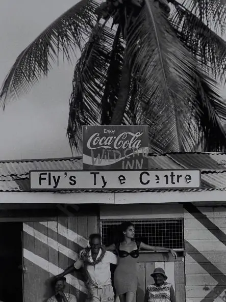 BISSELL, Christopher - Camera Press London - Relaxed Jamaicans alongside a model Image 1++